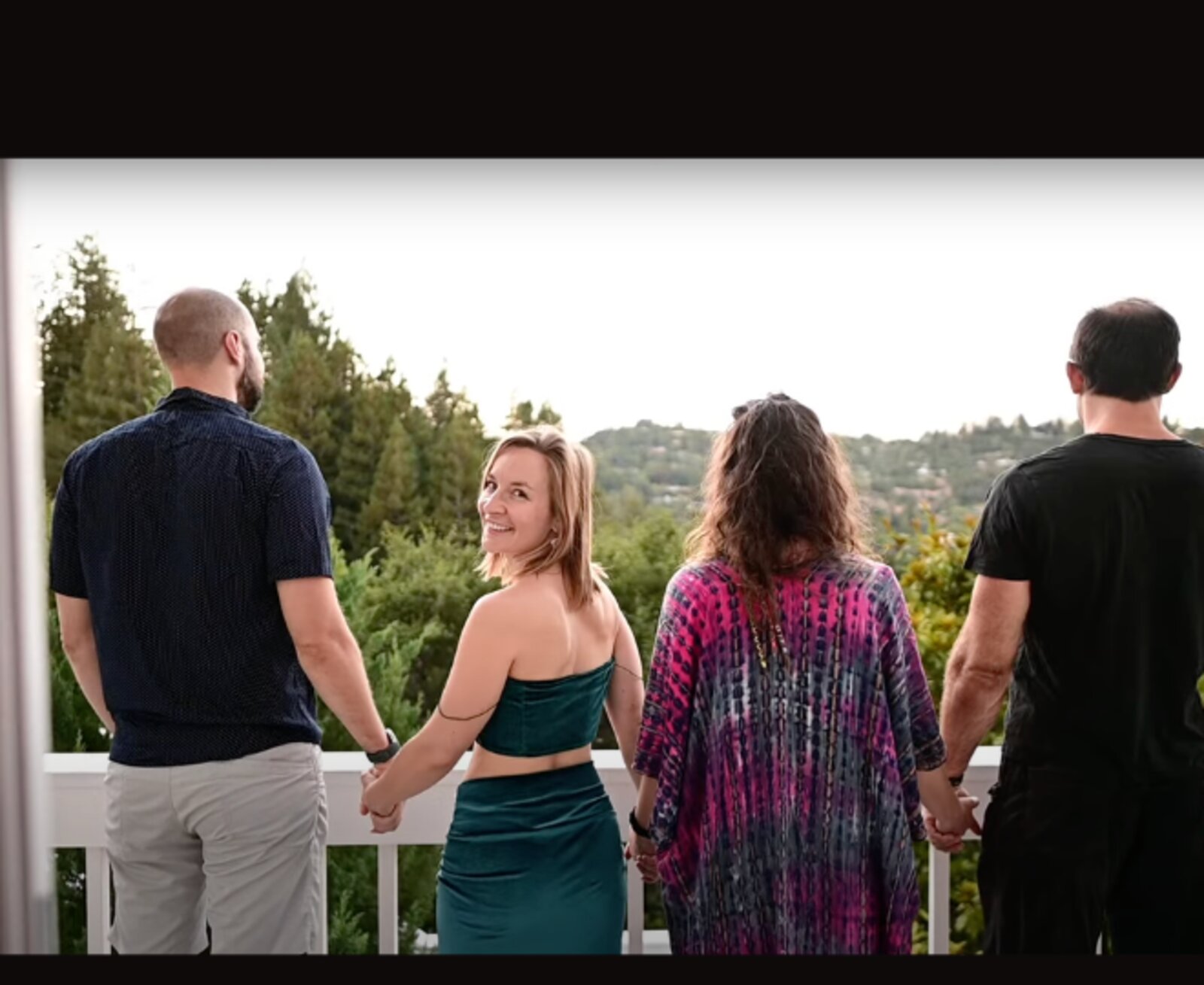 Guests holding hands at sunset before a Blindfolded dining experience